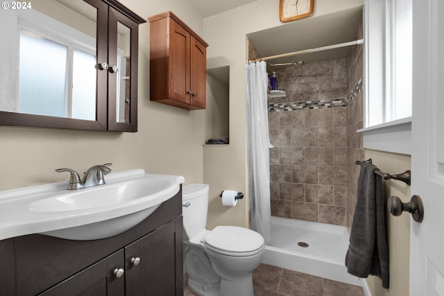 bathroom with walk in shower, vanity, tile patterned flooring, and toilet