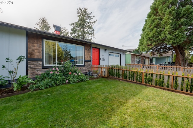 single story home featuring a garage and a front lawn