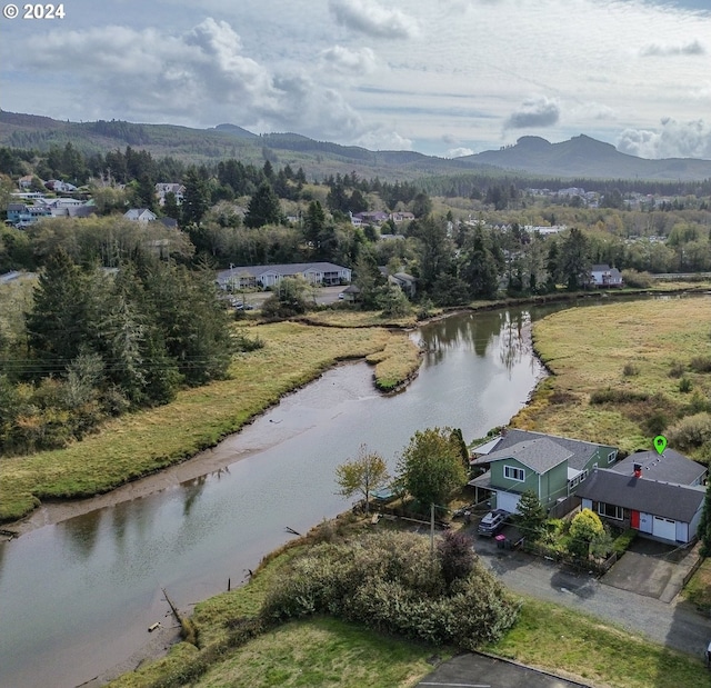 bird's eye view with a water and mountain view