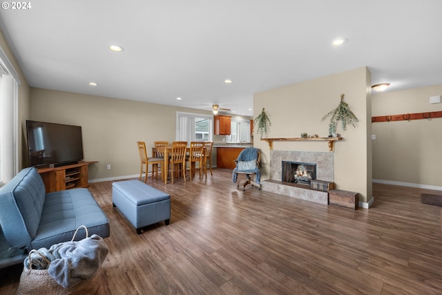 living room with ceiling fan, dark hardwood / wood-style floors, and a high end fireplace