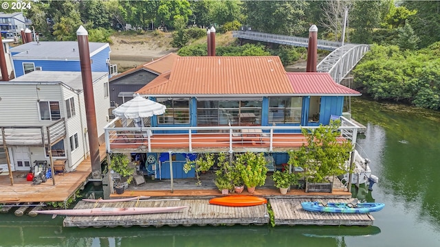 rear view of house featuring a water view