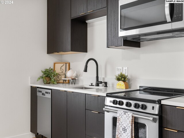 kitchen with sink and appliances with stainless steel finishes