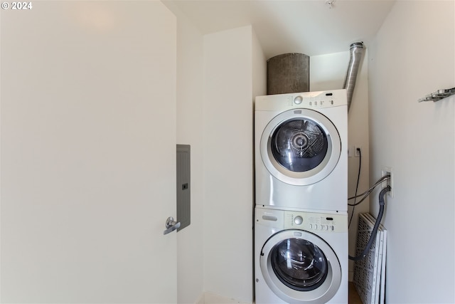 washroom with stacked washing maching and dryer