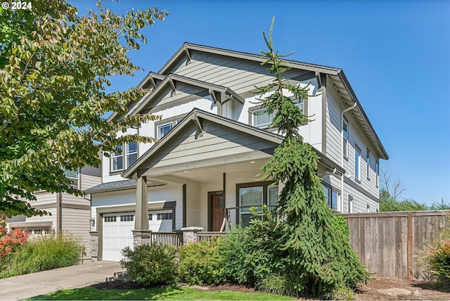 craftsman house with a porch and a garage