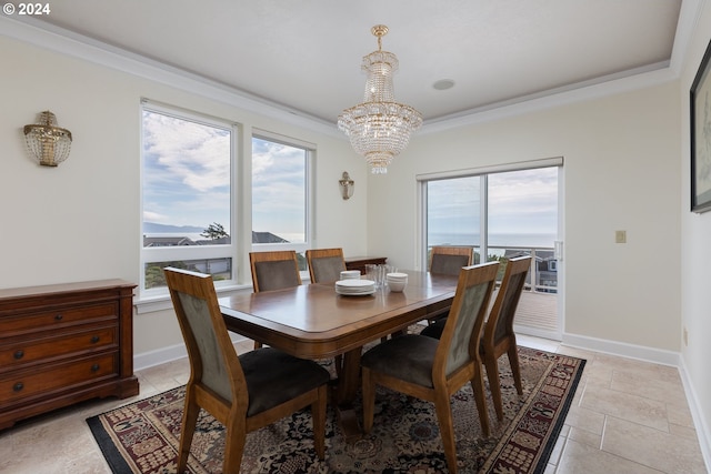 tiled dining area featuring an inviting chandelier, ornamental molding, and a healthy amount of sunlight