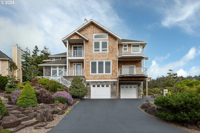 view of front of home with a garage and a balcony