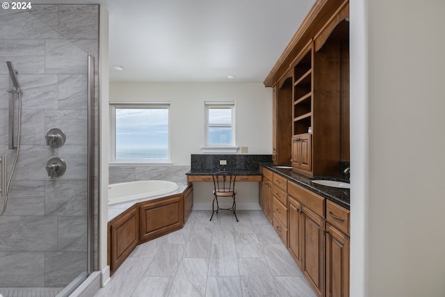 bathroom featuring shower with separate bathtub, tile patterned floors, and vanity