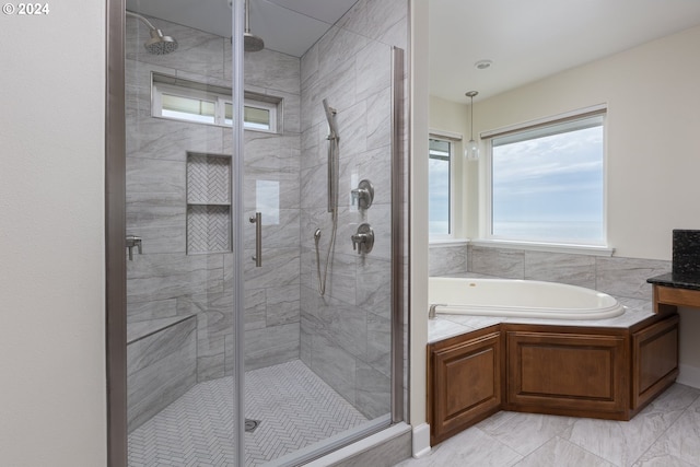 full bath with marble finish floor, a shower stall, and a bath