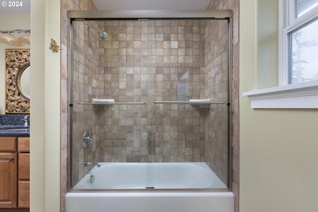 full bathroom with shower / bath combination with glass door and vanity