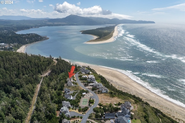 drone / aerial view with a view of the beach and a water and mountain view