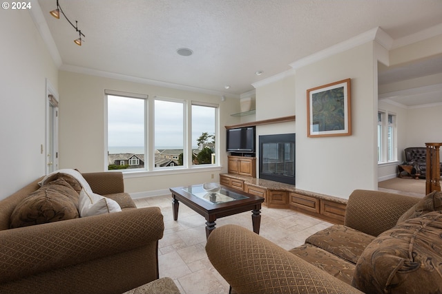 living room featuring a textured ceiling, crown molding, light tile patterned flooring, and rail lighting