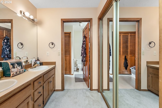 bathroom with vanity, toilet, and tile patterned flooring