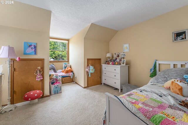 bedroom featuring light colored carpet, a textured ceiling, and vaulted ceiling