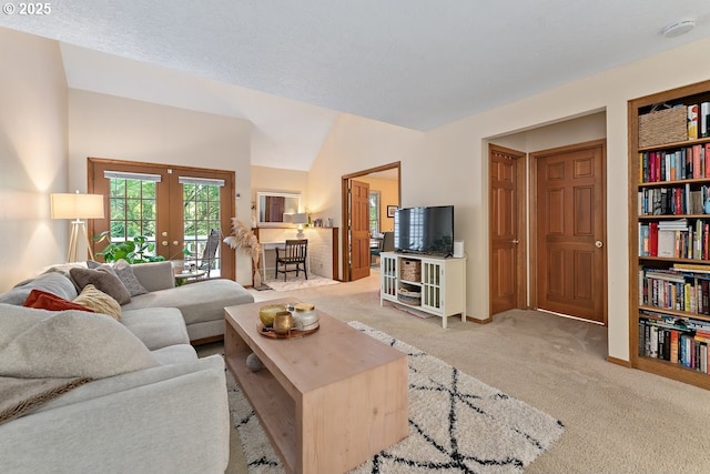 carpeted living room featuring french doors and lofted ceiling