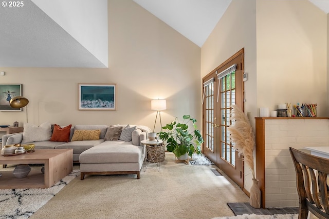 living room featuring light carpet, lofted ceiling, and french doors