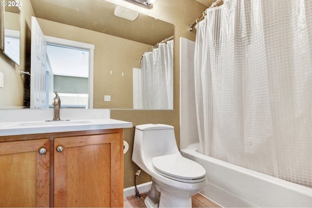 full bathroom with hardwood / wood-style floors, vanity, toilet, and shower / bath combo with shower curtain