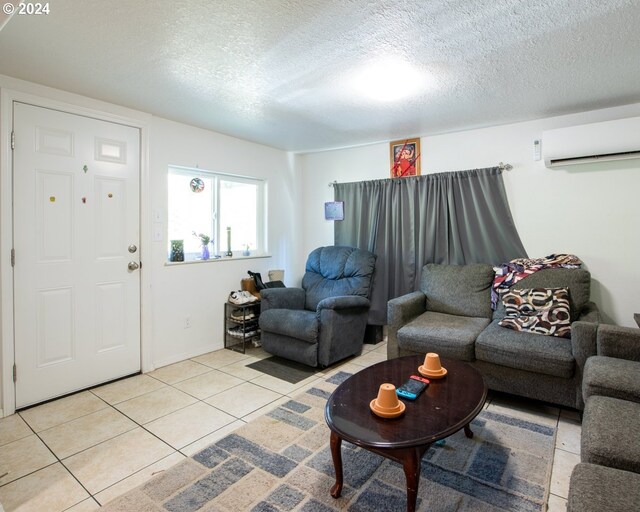 tiled living room featuring a textured ceiling and a wall mounted air conditioner