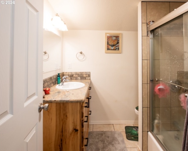 full bathroom featuring tile flooring, combined bath / shower with glass door, toilet, and large vanity