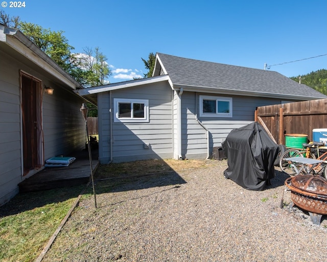 view of side of property featuring a fire pit