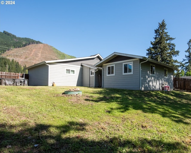 back of house with a lawn