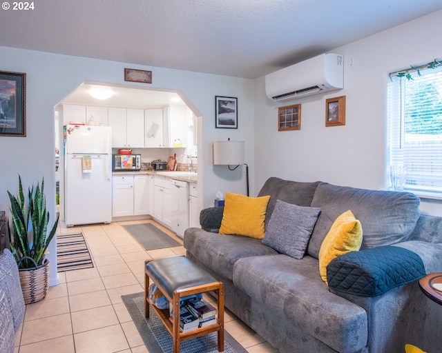 tiled living room featuring sink and a wall mounted air conditioner