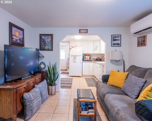 tiled living room featuring a wall unit AC