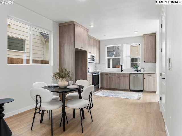 6905 N Bank St, Portland, OR 97203 - kitchen with appliances with stainless steel finishes, light wood-style floors, light countertops, baseboards, and recessed lighting