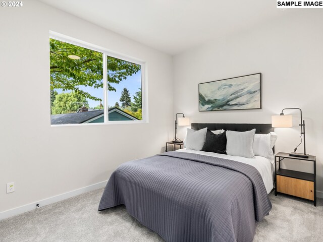 bedroom featuring light carpet