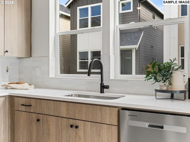 6905 N Bank St, Portland, OR 97203 - kitchen with dishwasher, a sink, backsplash, and light countertops
