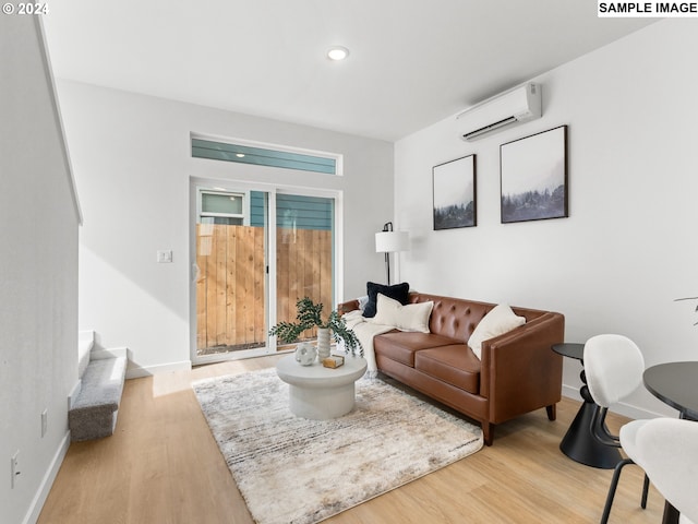 6905 N Bank St, Portland, OR 97203 - living room featuring an AC wall unit, wood finished floors, baseboards, and recessed lighting