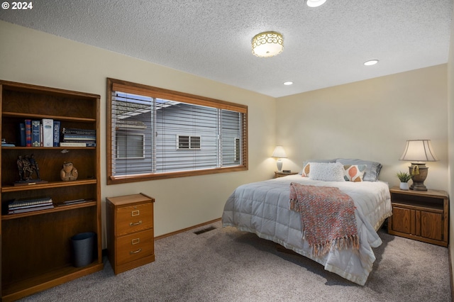 carpeted bedroom with a textured ceiling