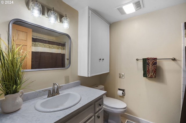 bathroom with toilet, vanity, and a shower with shower curtain