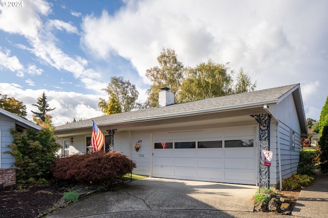 15775 SW Queen Victoria Pl, King City, OR 97224 - ranch-style house with concrete driveway, a chimney, and a garage