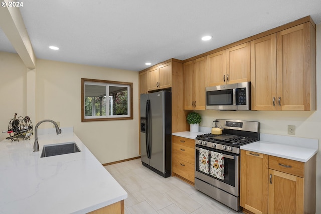 15775 SW Queen Victoria Pl, King City, OR 97224 - kitchen featuring a peninsula, baseboards, recessed lighting, a sink, and appliances with stainless steel finishes