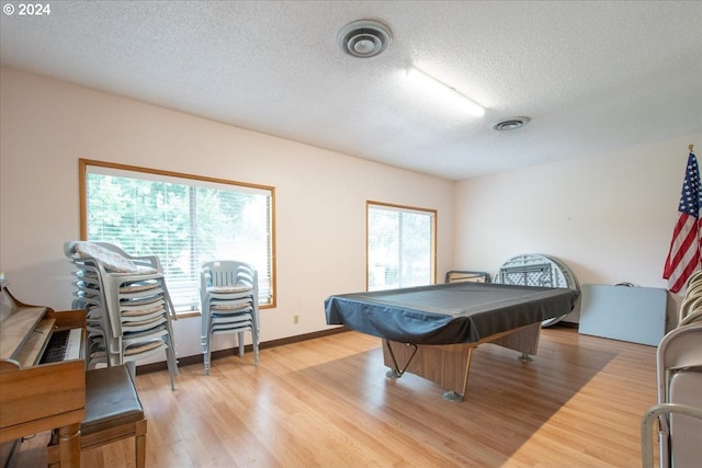 playroom with light wood-type flooring, a textured ceiling, and pool table