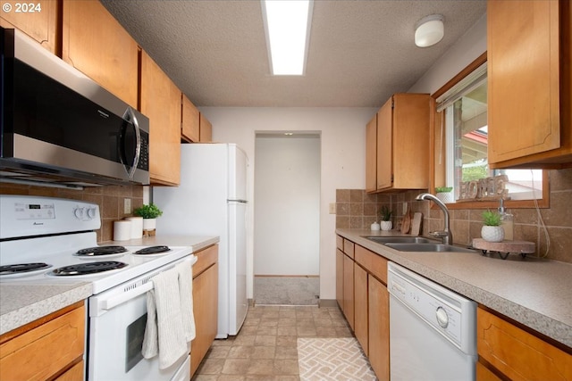 kitchen featuring decorative backsplash, sink, white appliances, and light tile patterned floors