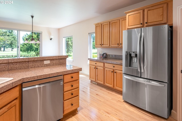 laundry room with washing machine and dryer, baseboards, and laundry area