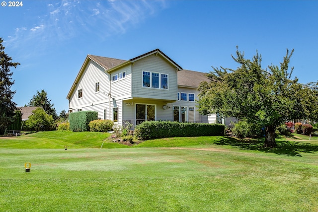 traditional-style home featuring concrete driveway, an attached garage, and a tiled roof