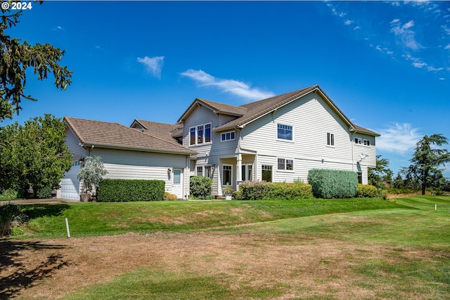 view of side of home featuring a tiled roof, a yard, concrete driveway, a mountain view, and a garage