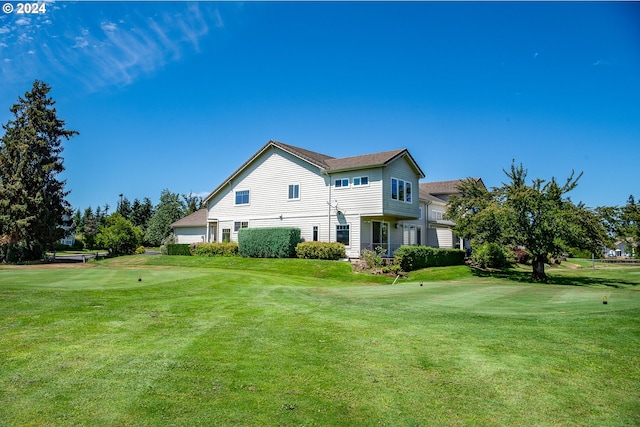 rear view of property with a yard