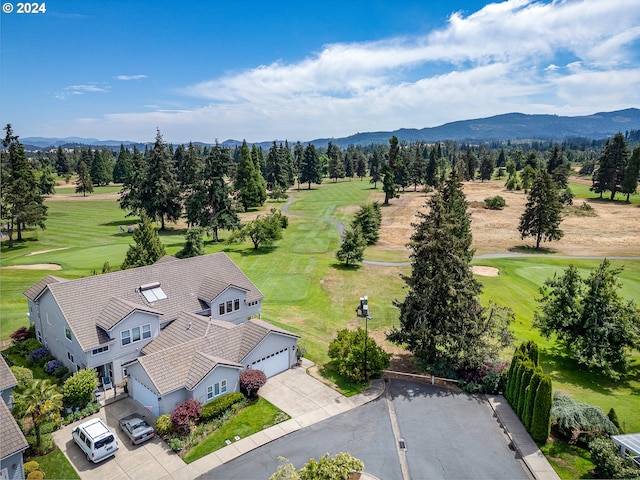 birds eye view of property with view of golf course and a mountain view