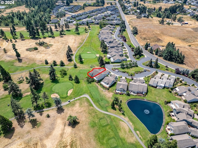 birds eye view of property featuring a residential view, a water view, and view of golf course