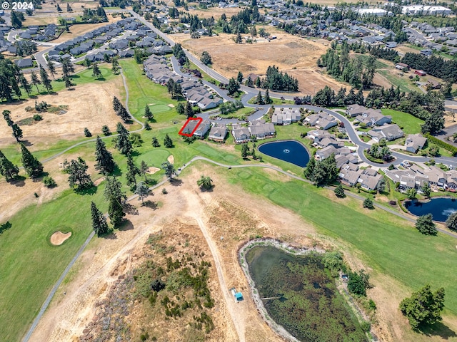 bird's eye view featuring view of golf course, a water view, and a residential view