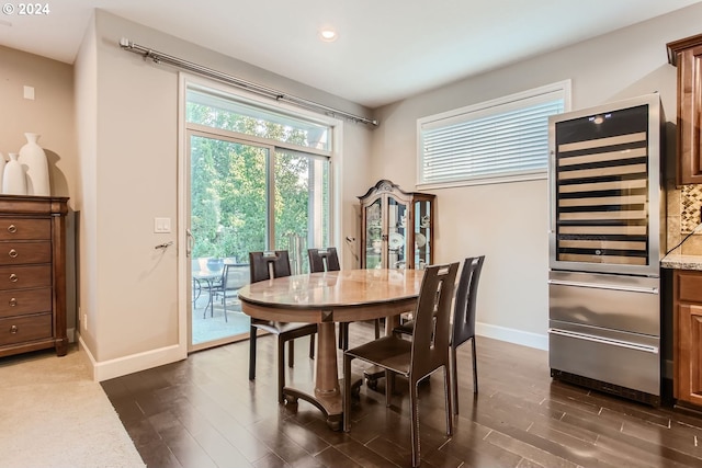 dining space with wine cooler, recessed lighting, dark wood finished floors, and baseboards