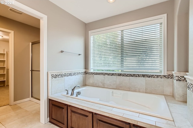 bathroom with a garden tub, visible vents, a spacious closet, a stall shower, and tile patterned floors