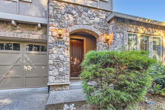 view of exterior entry with a garage