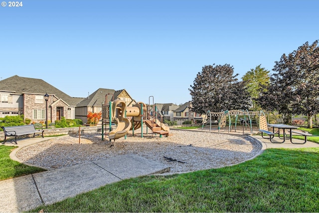 community jungle gym with a residential view and a yard