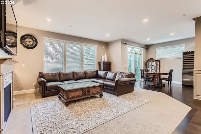 living room featuring recessed lighting, a fireplace, wood finished floors, and baseboards