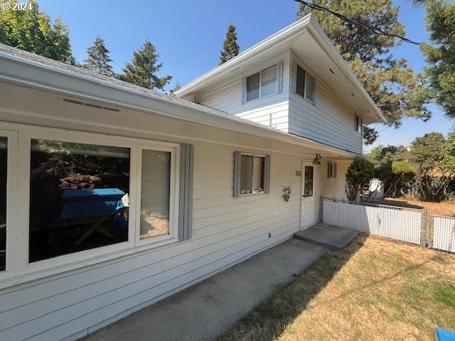 view of property exterior featuring a lawn