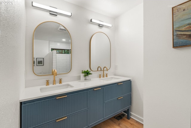 bathroom with vanity and hardwood / wood-style floors